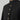 Black collared thobe close up with gold buttons on a gray background