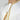 Model wearing a White collarless omani thobe with sophisticated gold embroidery on a plain background.